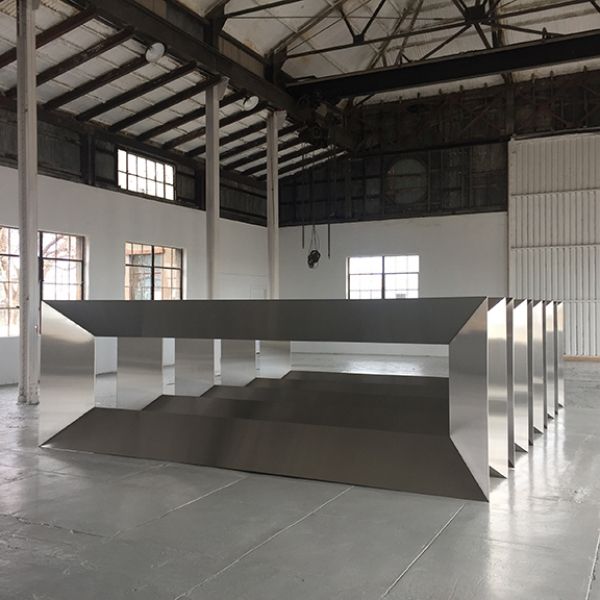 A large stainless steel table in a large room