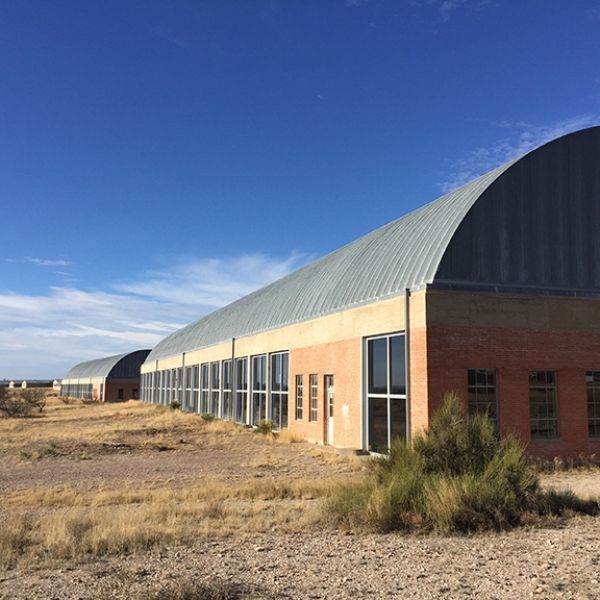 A large building with a curved roof and a lot of windows