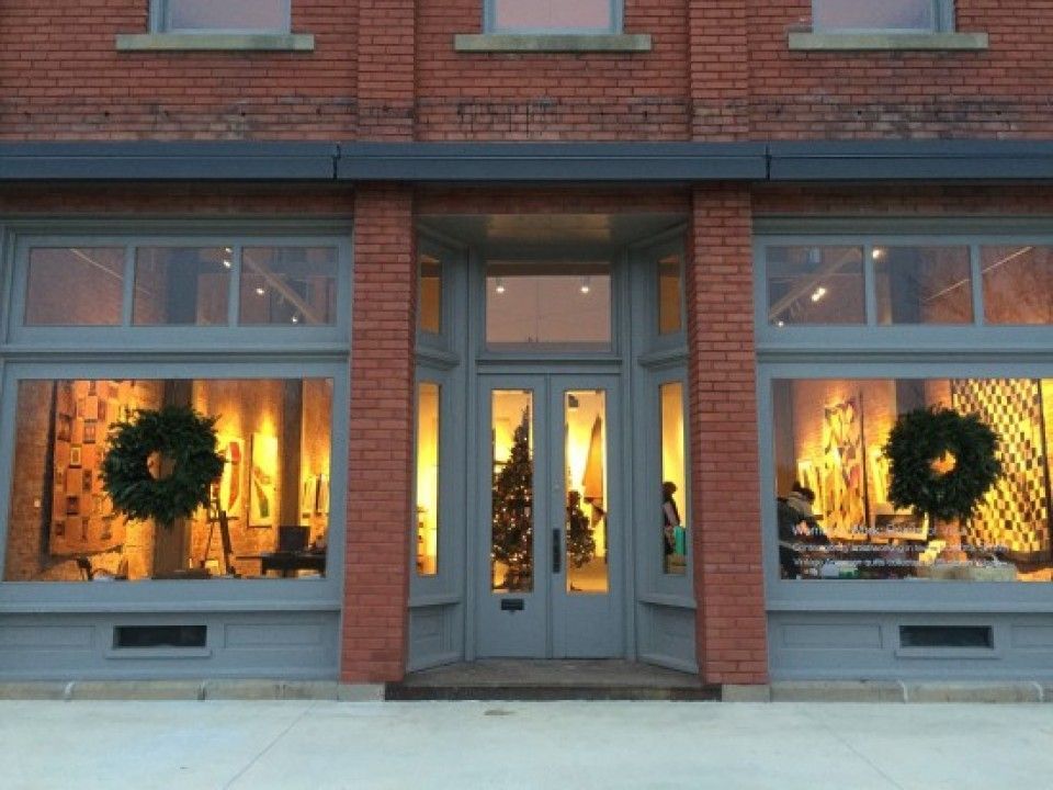 A brick building with a christmas tree in the window