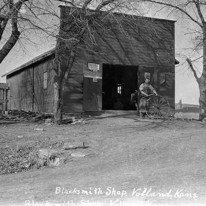 A black and white photo of a blacksmith shop in holland kansas