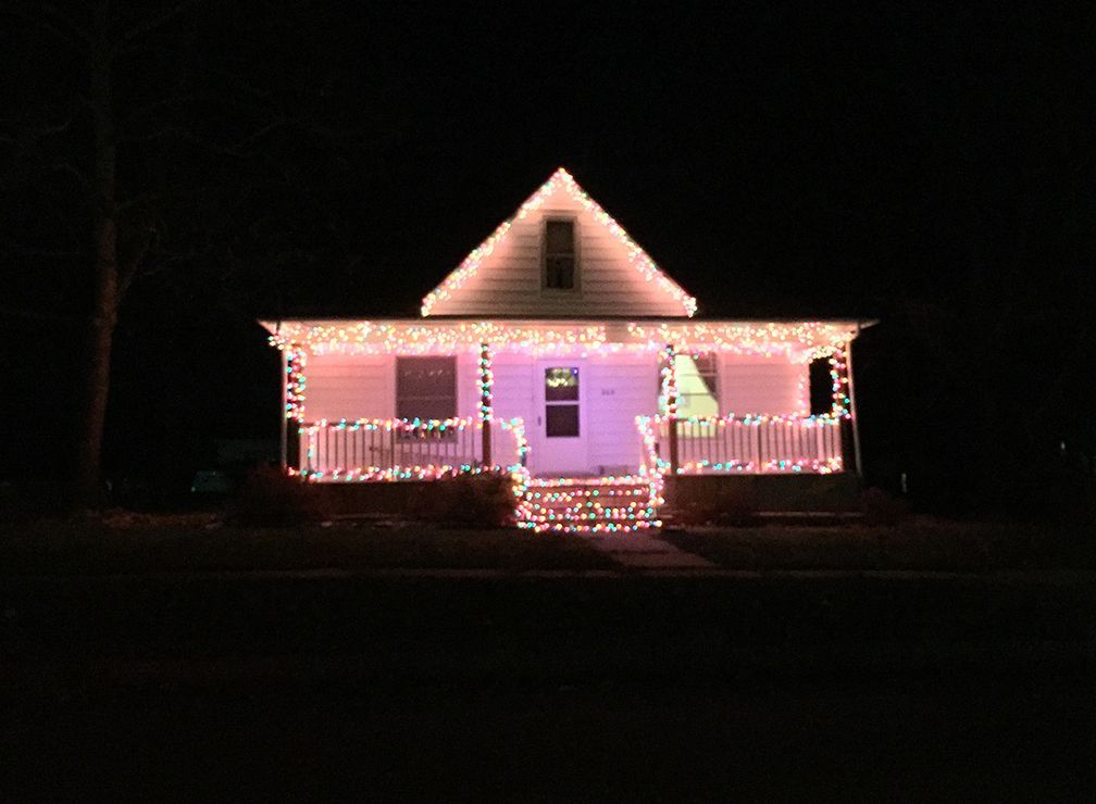 House at night decorated with colorful Christmas lights.