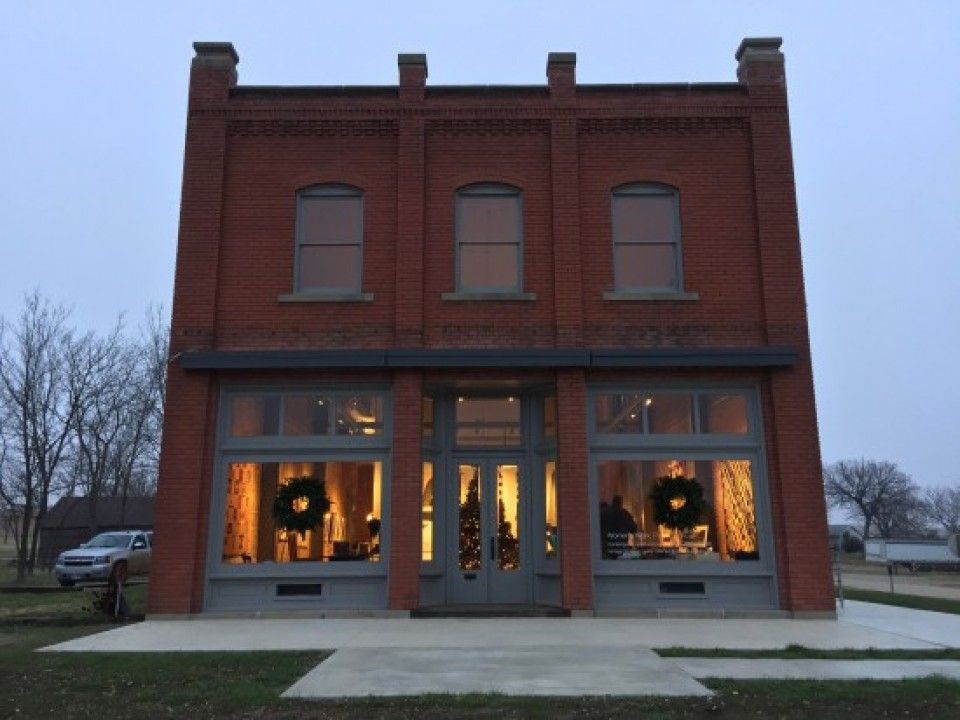 A large brick building with christmas wreaths in the windows