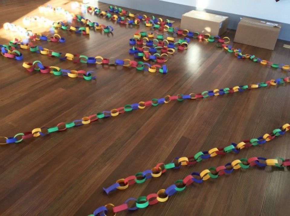 A bunch of colorful chains on a wooden floor