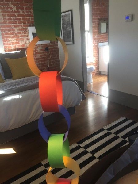 A colorful paper chain is hanging in a bedroom