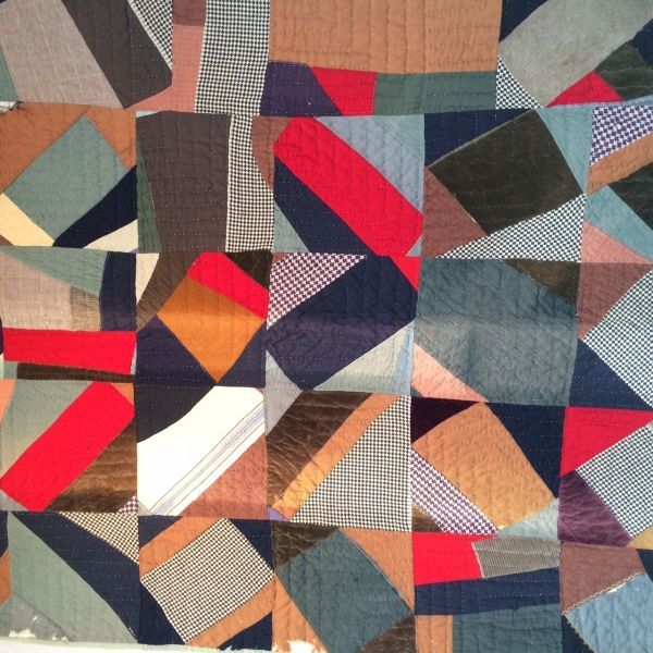 A close up of a quilt with a geometric pattern