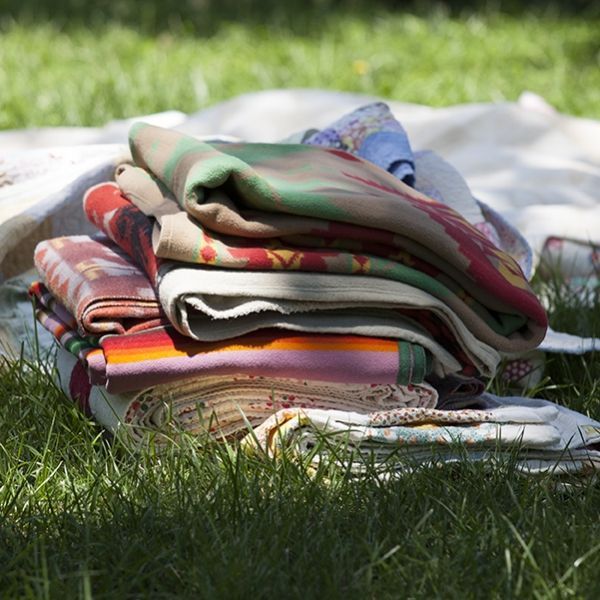 A stack of blankets is laying in the grass