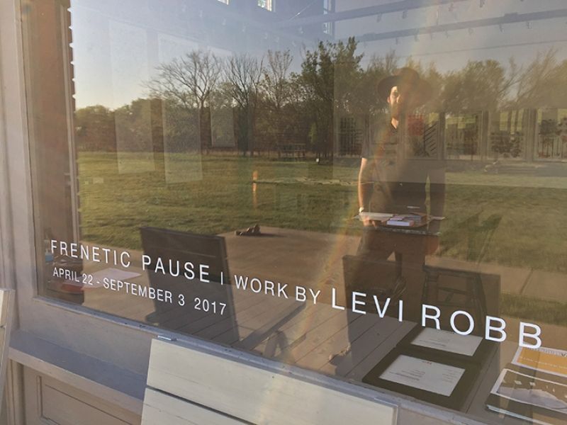 A window with the words frenetic pause work by levi robe on it