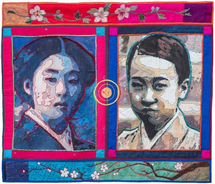 Quilt with two portraits: a woman in blue, a boy in sepia. Floral borders in pink and blue.