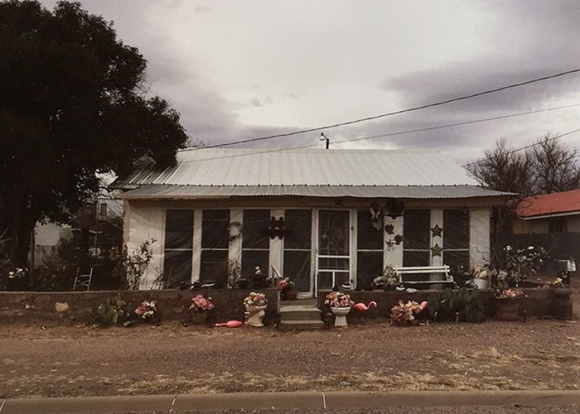 A small white house with a metal roof