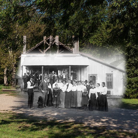A group of people standing in front of a white building