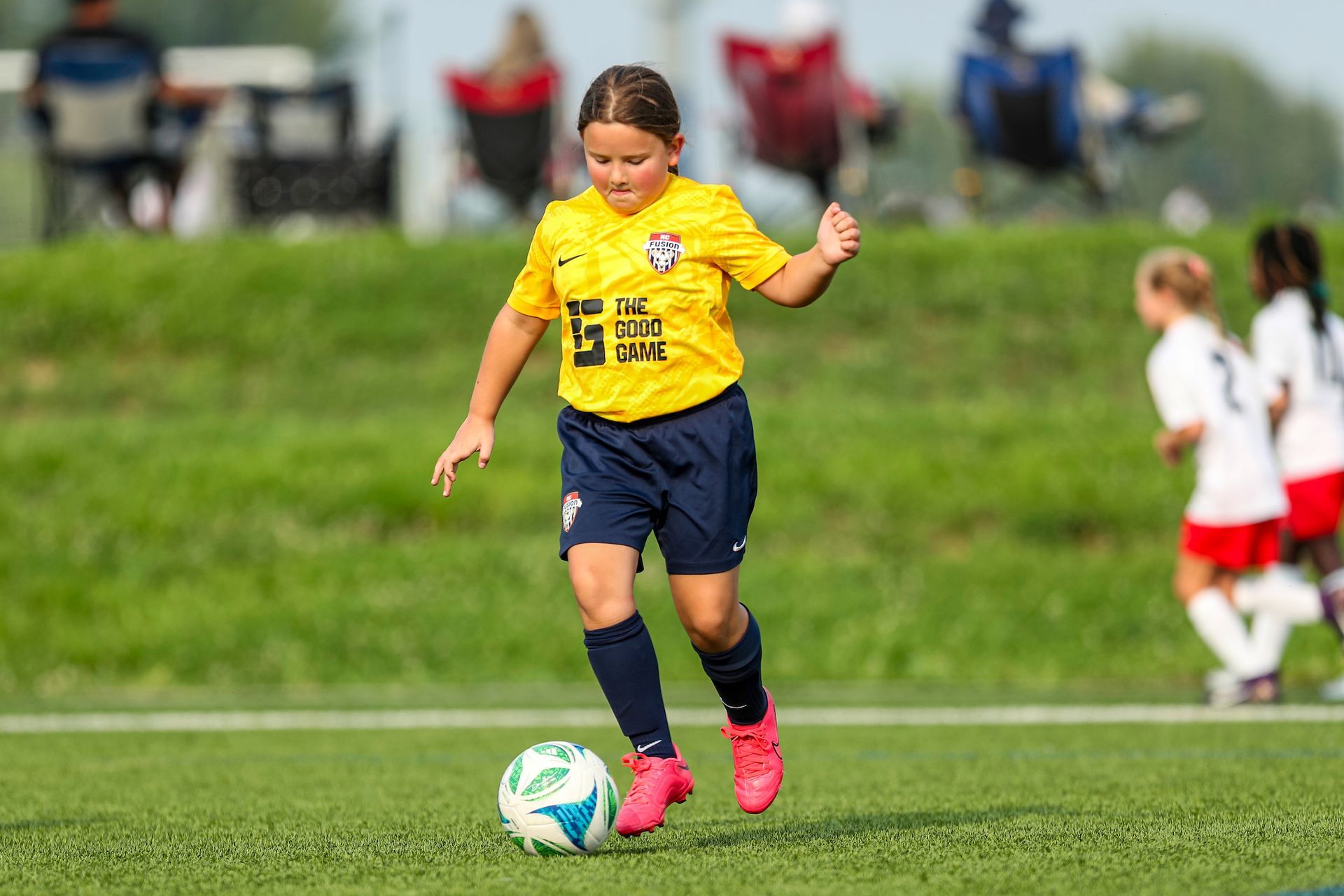 A young girl playing soccer for KC Fusion Soccer Club