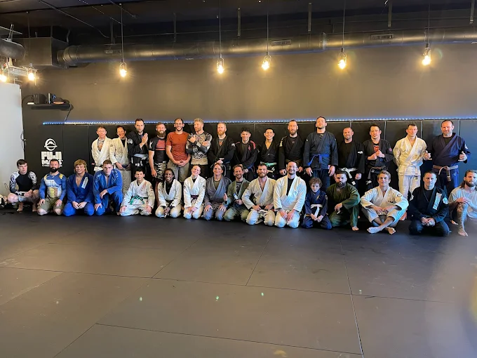 Adults practice Jiu-Jitsu drills at Speakeasy Jiu-Jitsu & Wrestling Academy in Asheville, NC for stress relief.