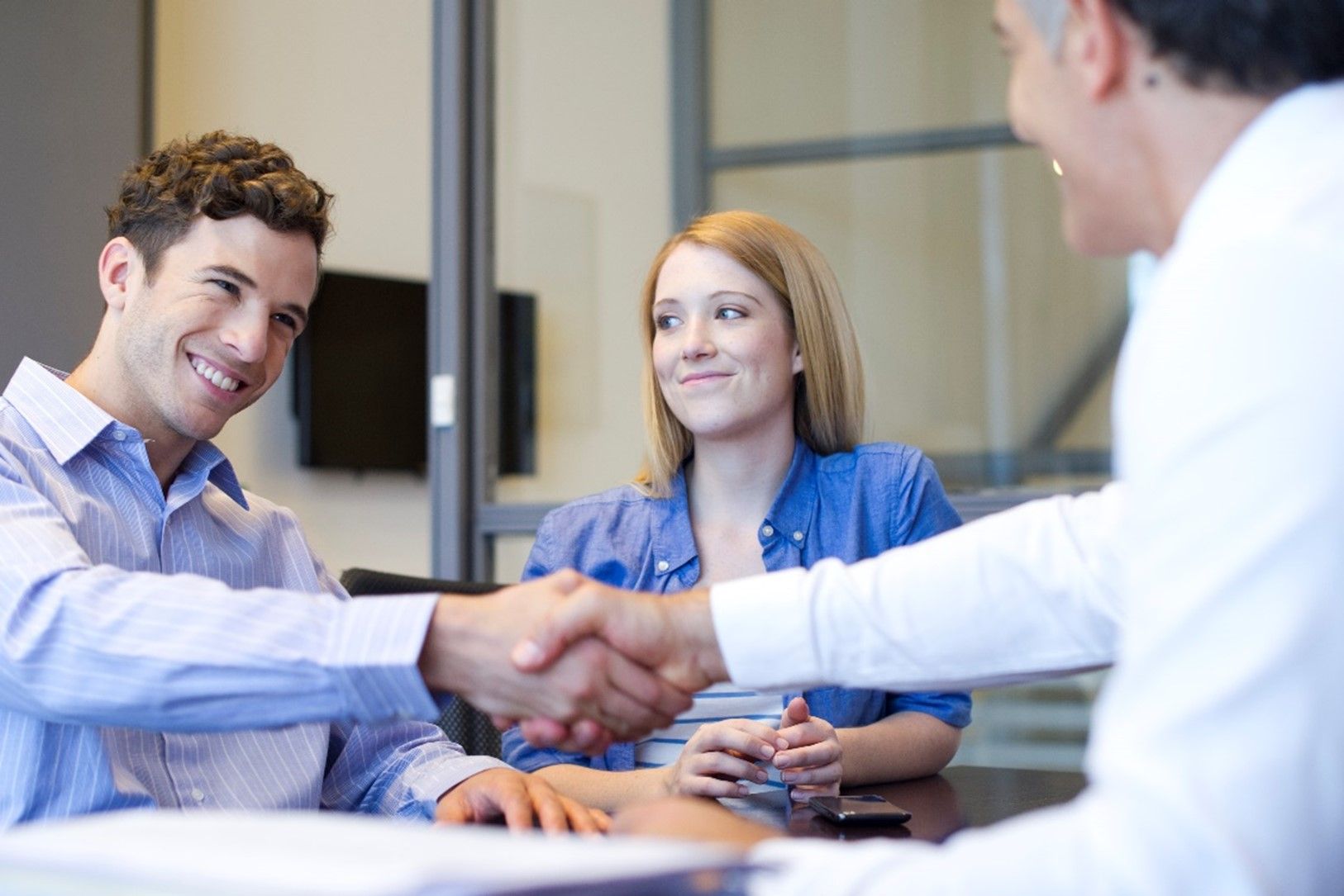 Central Finance team shaking hands, promoting Signature Loan Program in Abilene, TX