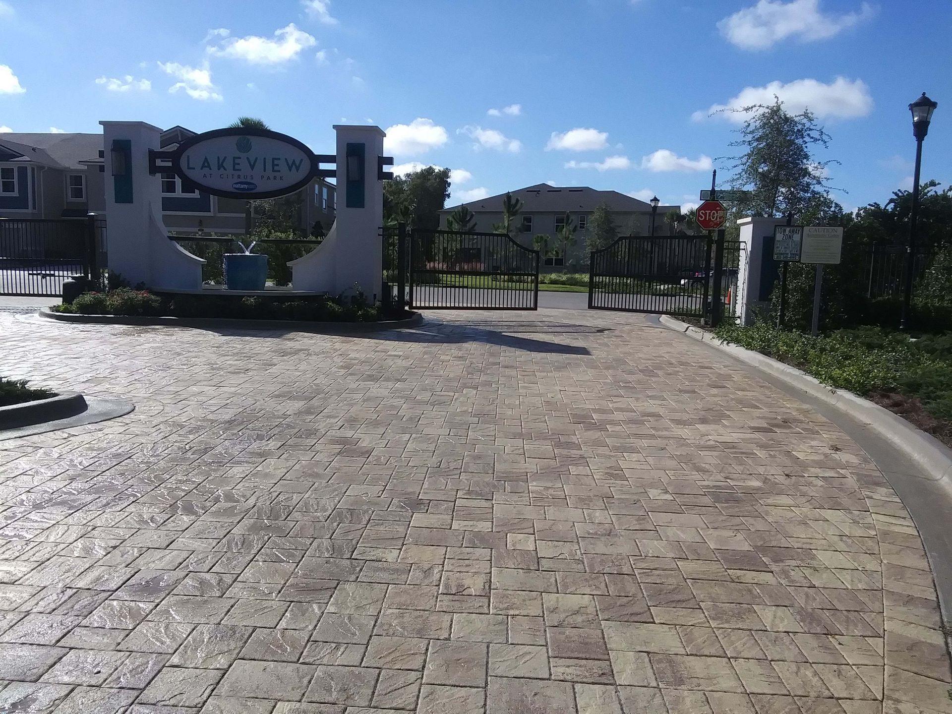 Brick road leads to a gated entrance of 