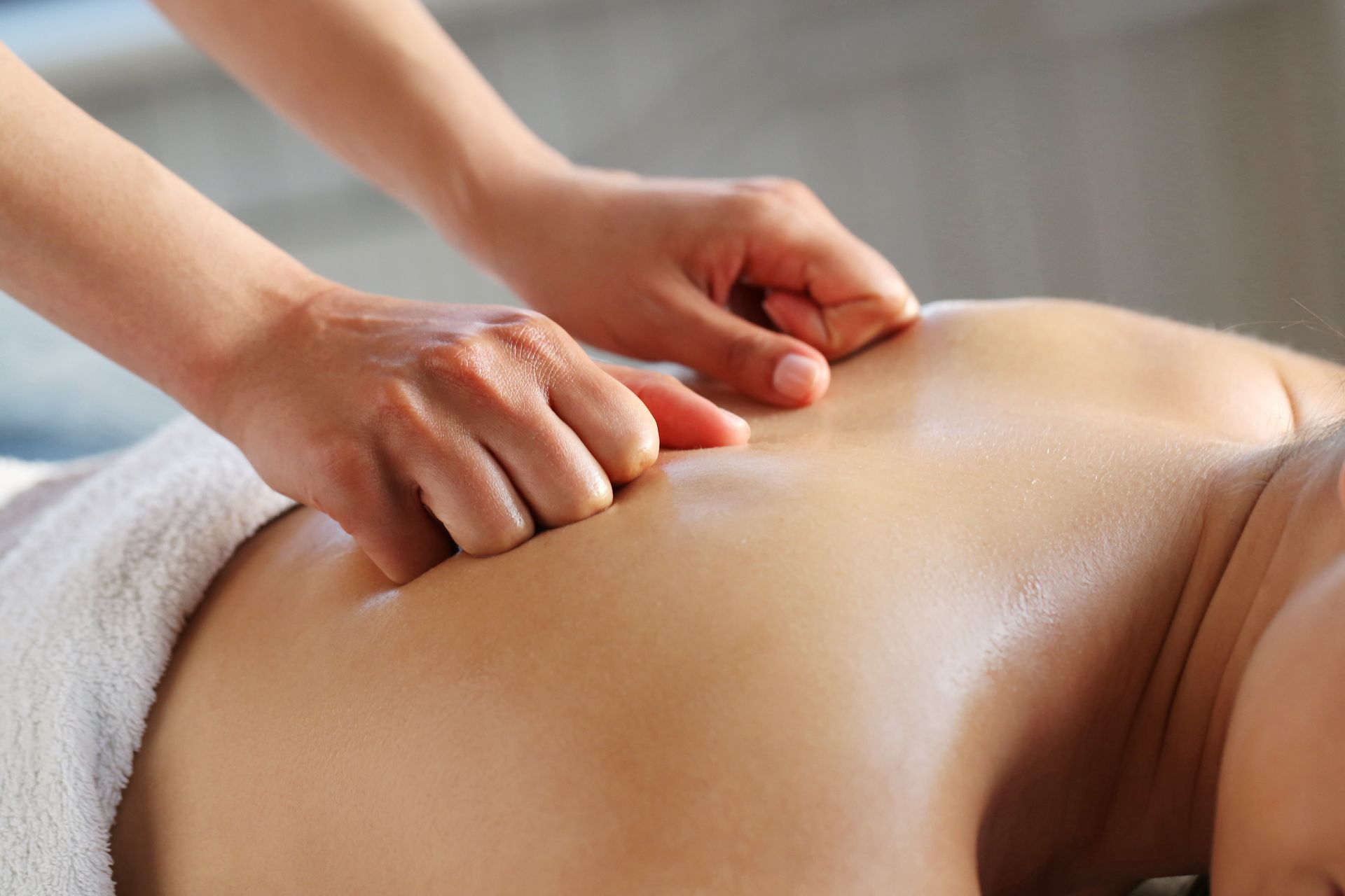 a woman is getting a massage on her back at the 19 Steps Skin and Body Studio.