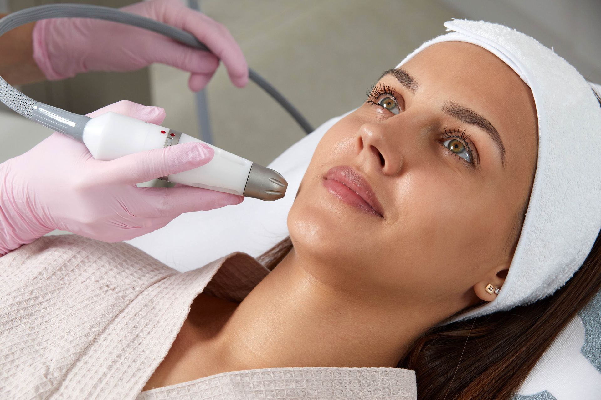 a woman is getting a microneedling  treatment at a beauty salon .
