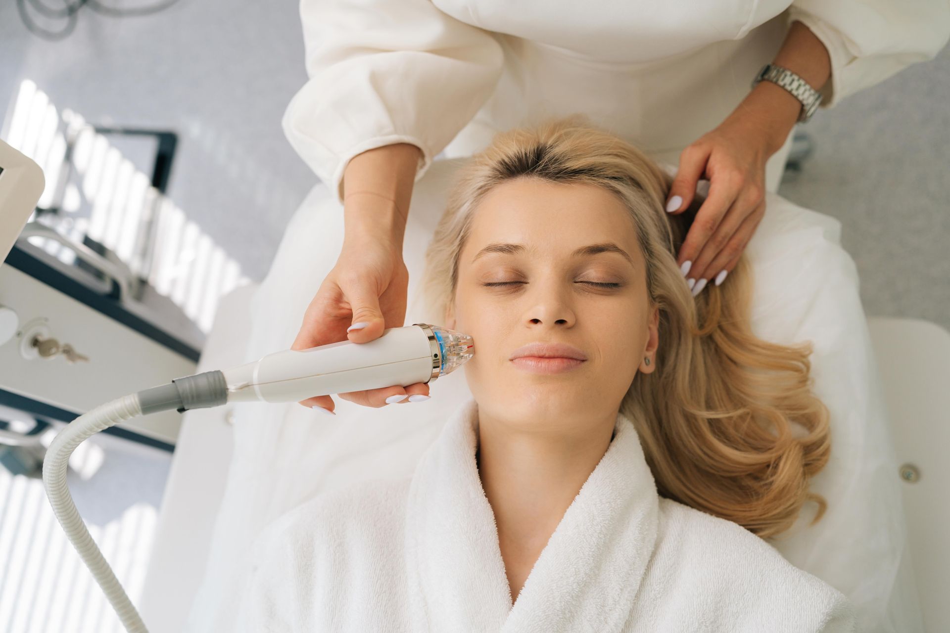 a woman is getting a facial treatment at a beauty salon .