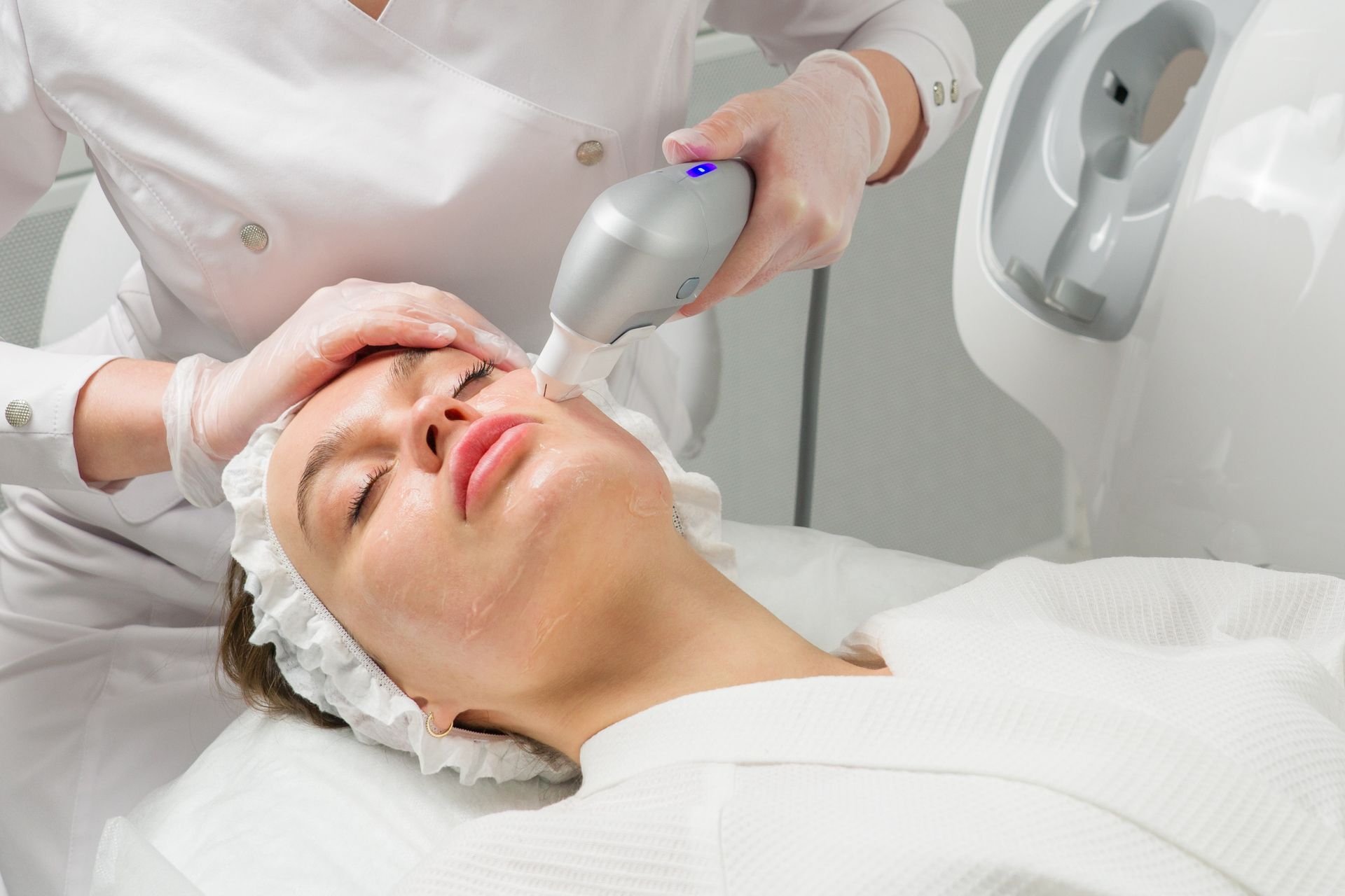 a woman is getting a laser treatment on her face .