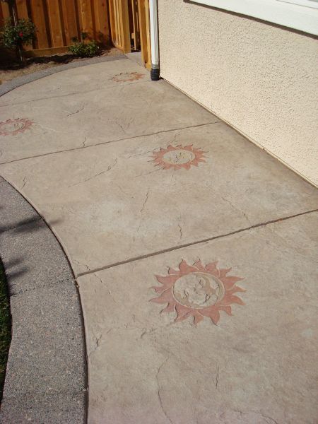 A concrete walkway with a sun design on it