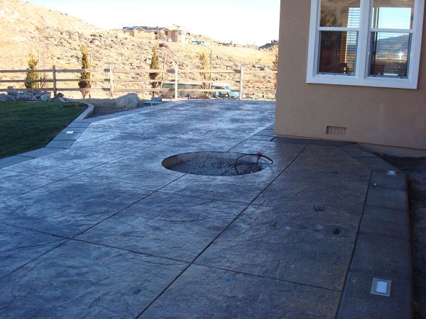 A concrete patio with a hole in the middle of it
