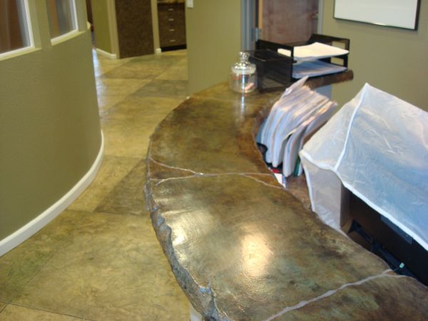 A curved counter in a hallway with papers on it