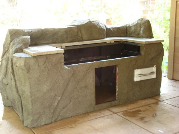 A concrete couch with a drawer underneath it