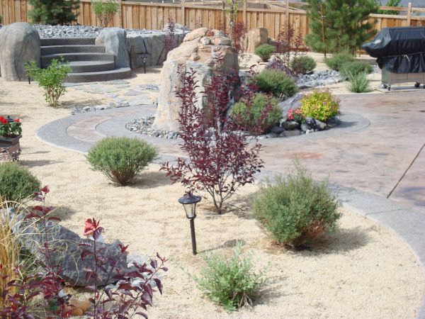 A backyard with a grill and stairs in the background
