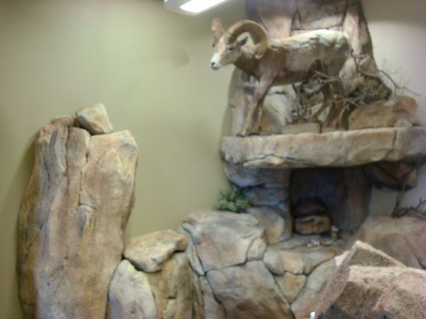 A statue of a ram standing on top of a rock