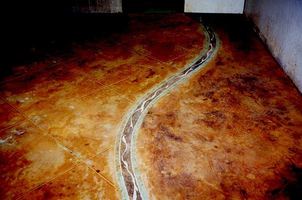 A concrete floor with a snake design on it.