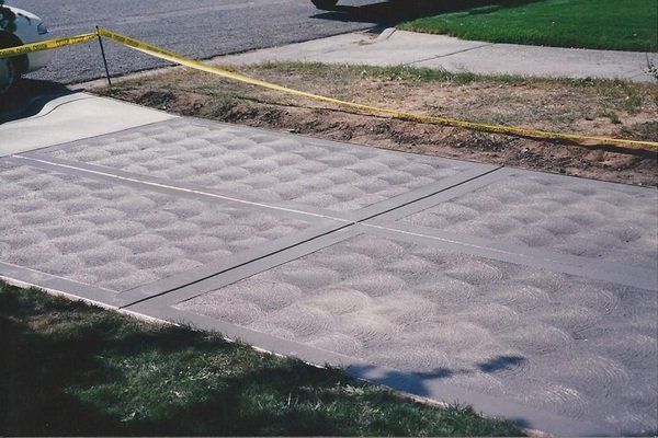 A concrete sidewalk with a yellow tape around it