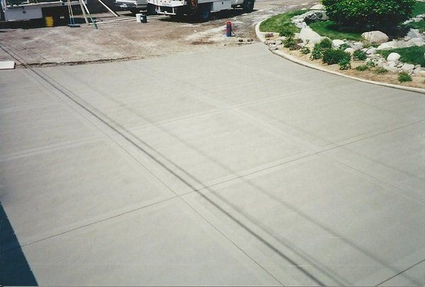 A concrete driveway with a fire hydrant in the middle