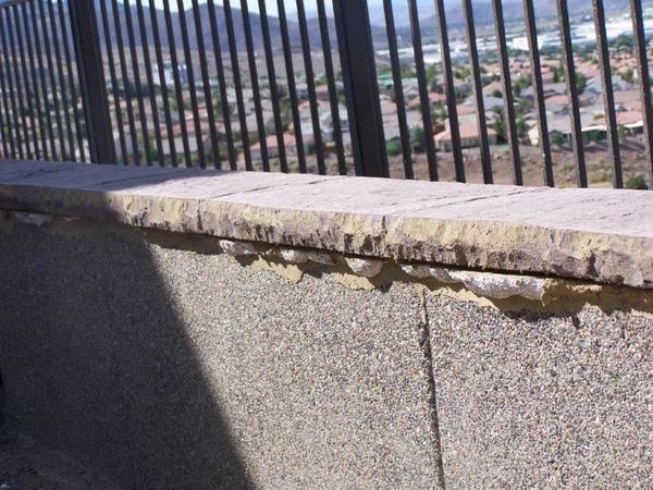 A fence with a view of a city behind it