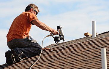 Roofing Restoration — Man Fixing Roof in Waukesha, WI
