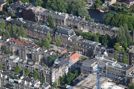 an aerial view of a city with lots of buildings and trees