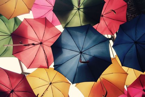 a bunch of colorful umbrellas hanging from the ceiling