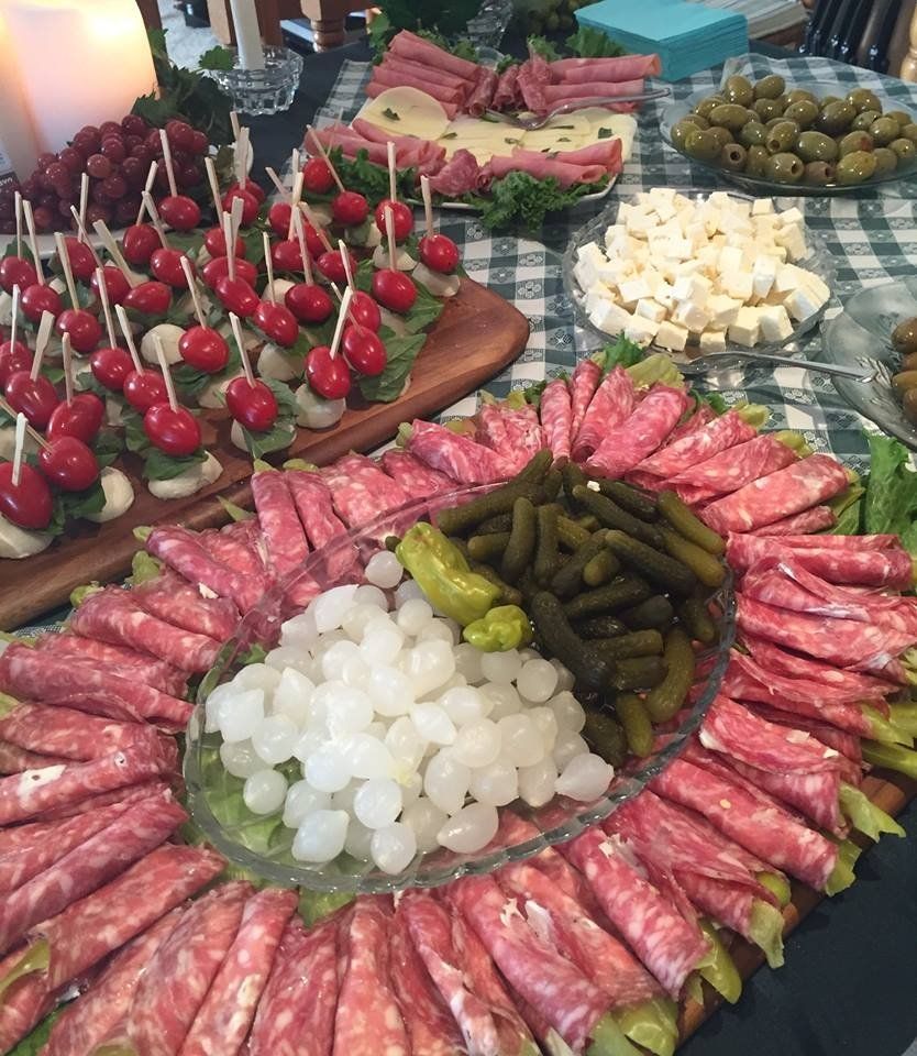 various appetizer plates with meats, skewers and vegetables