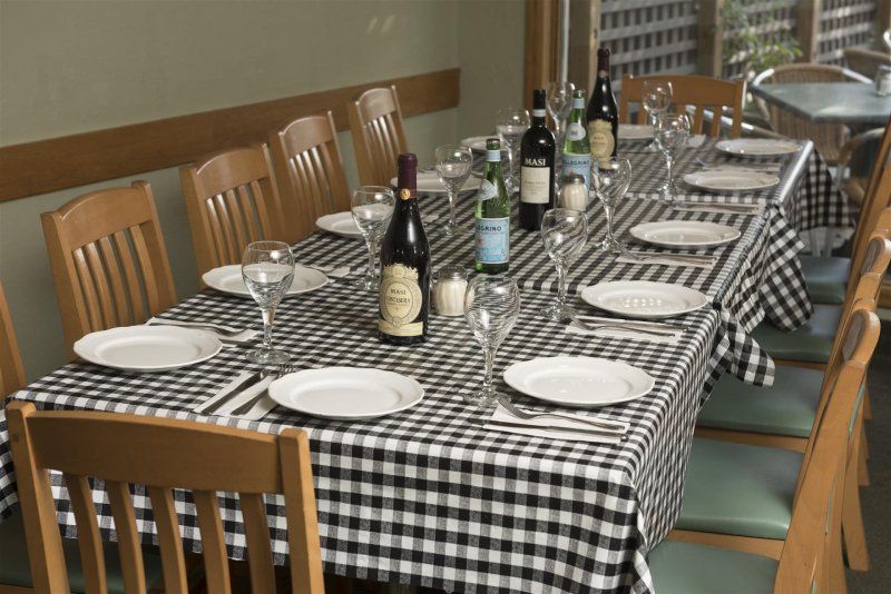 Table setting with plates, glasses, bottles with chairs