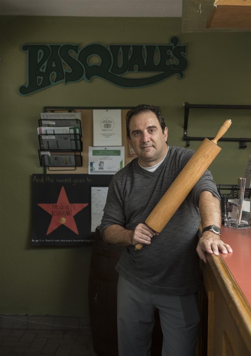 Chef posing for the camera holding a rolling pin