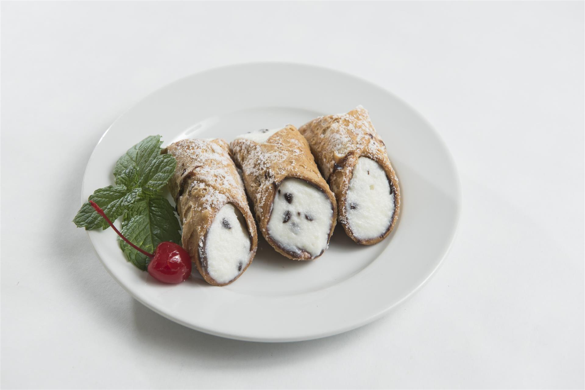 three cannoli's on a  plate
