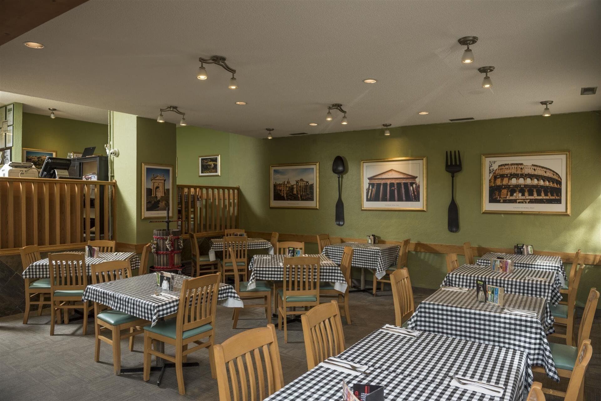 interior of dining room with chairs and tables with photos on the walls, a silverwear decor