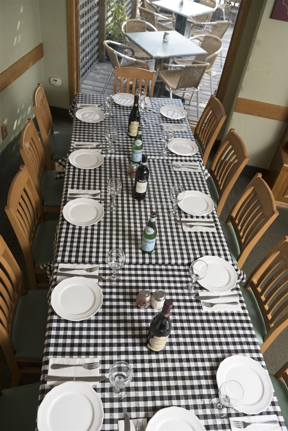 Table setting with plates, glasses, bottles with chairs