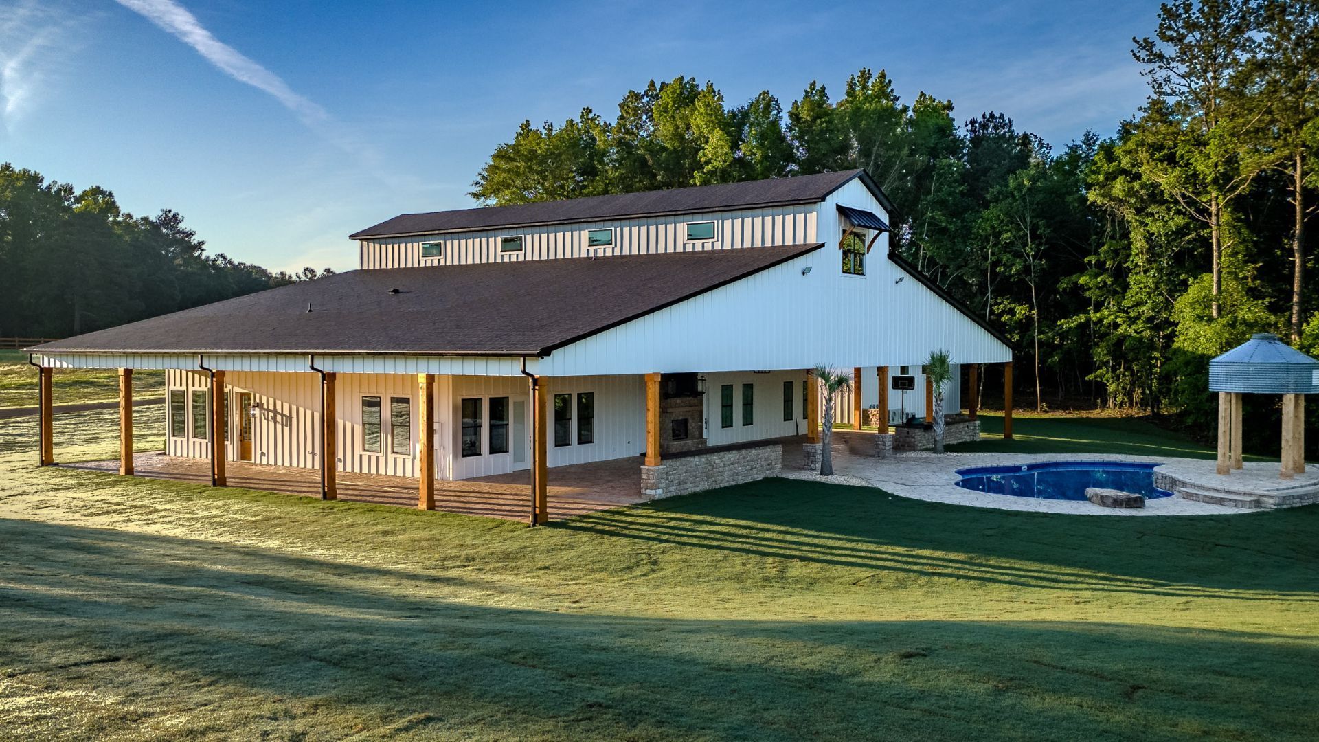 A large white house with a pool in the backyard