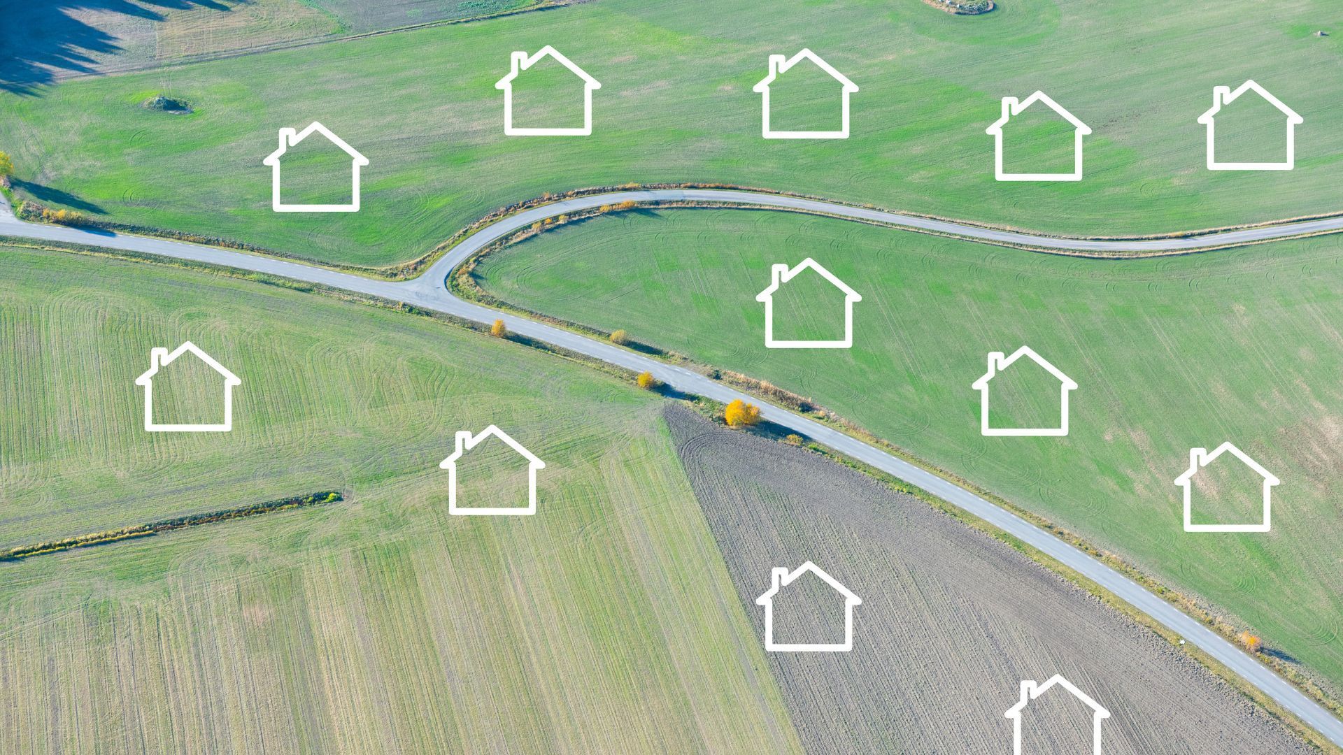 An aerial view of a residential area with houses and a road.