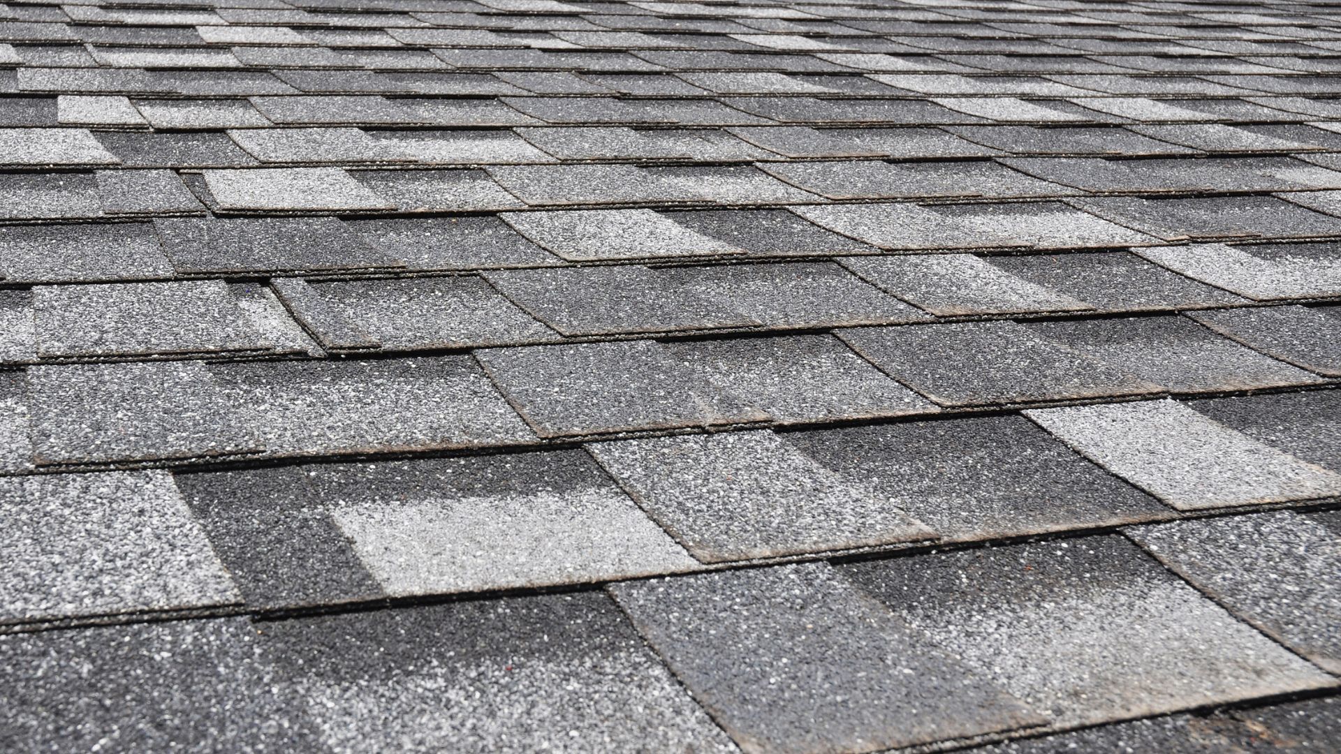 A close up of a roof with a lot of shingles on it.