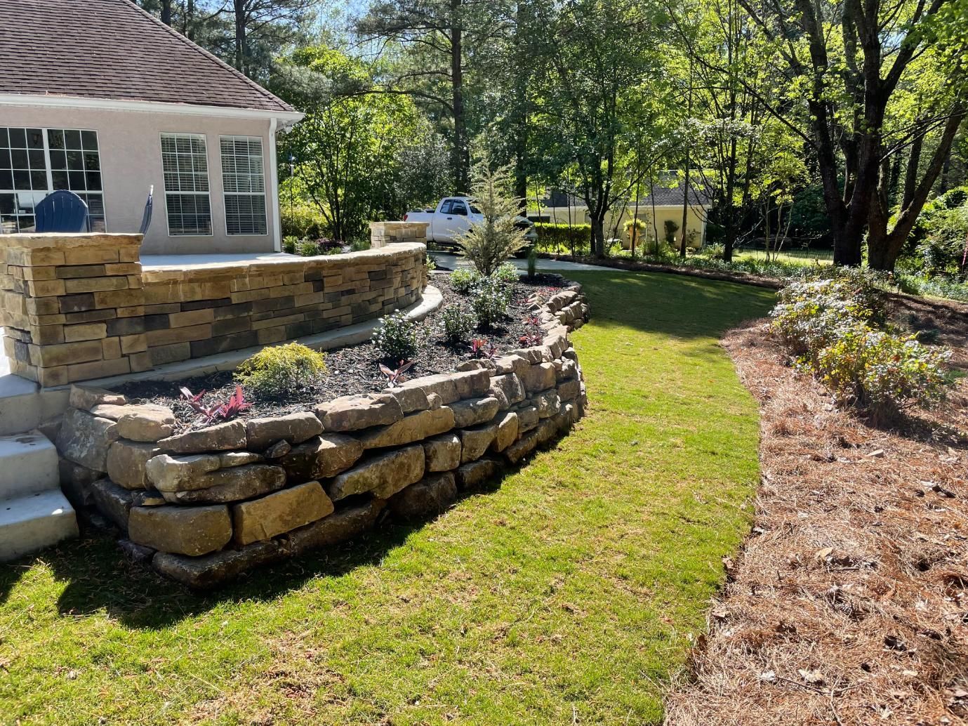 There is a stone wall in the middle of the yard.