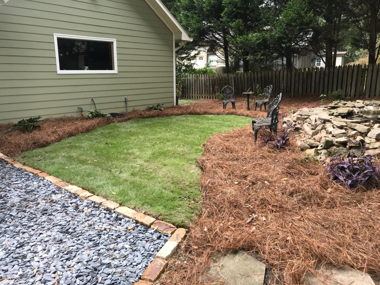 A house with a large lawn in front of it.