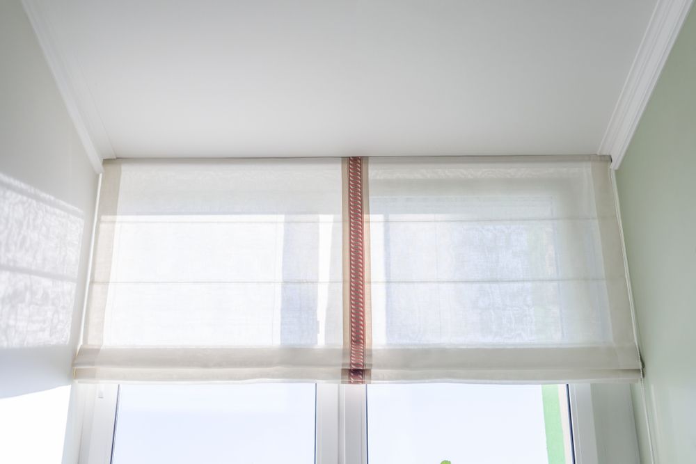 White Roman Shades Covering a Window — BlindDESIGN in Byron Bay, NSW