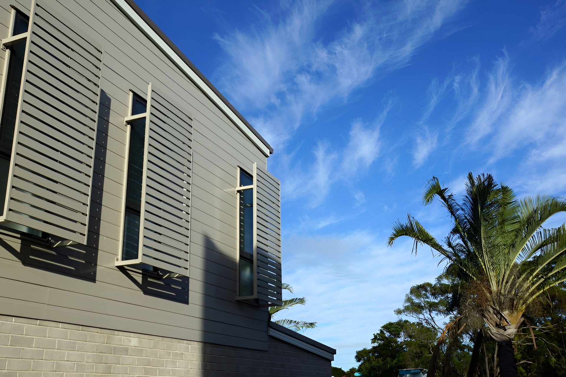 Gray Building with Shuttered Windows — BlindDESIGN in Byron Bay, NSW
