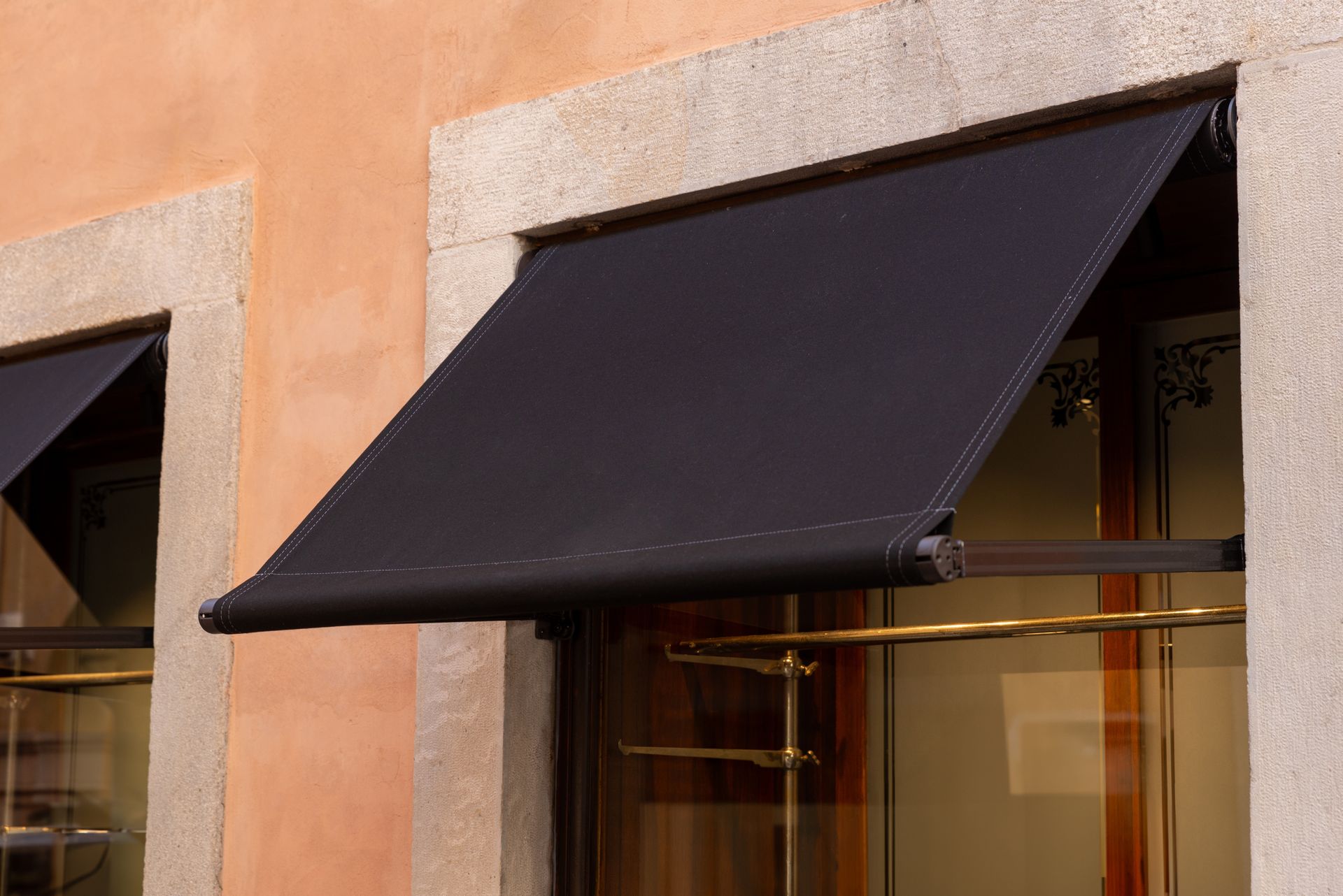 Black Awning Over a Shop Window on A Salmon-Colored Building — BlindDESIGN in Byron Bay, NSW
