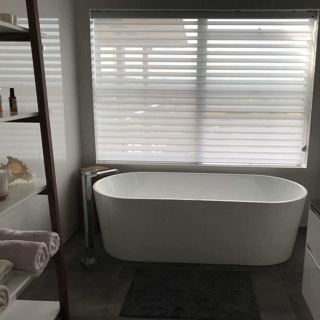 Freestanding White Bathtub in a Bathroom, Under a Window With Blinds — BlindDESIGN in Byron Bay, NSW